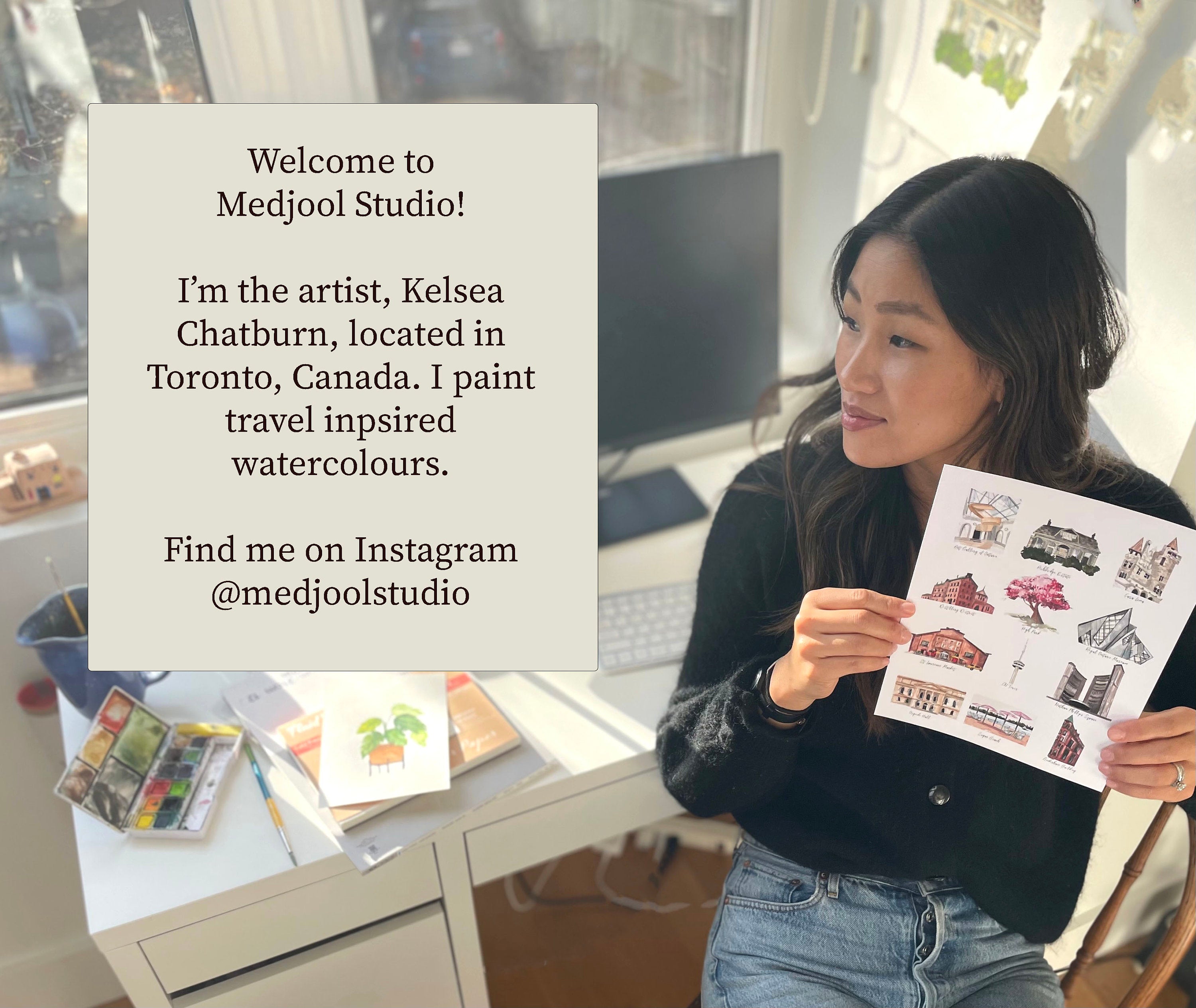 Kelsea Chatburn, Owner of Medjool Studio Print Shop. Located in Toronto, Ontario. Kelsea is holding a photo of her travel inspired watercolour paintings. 
