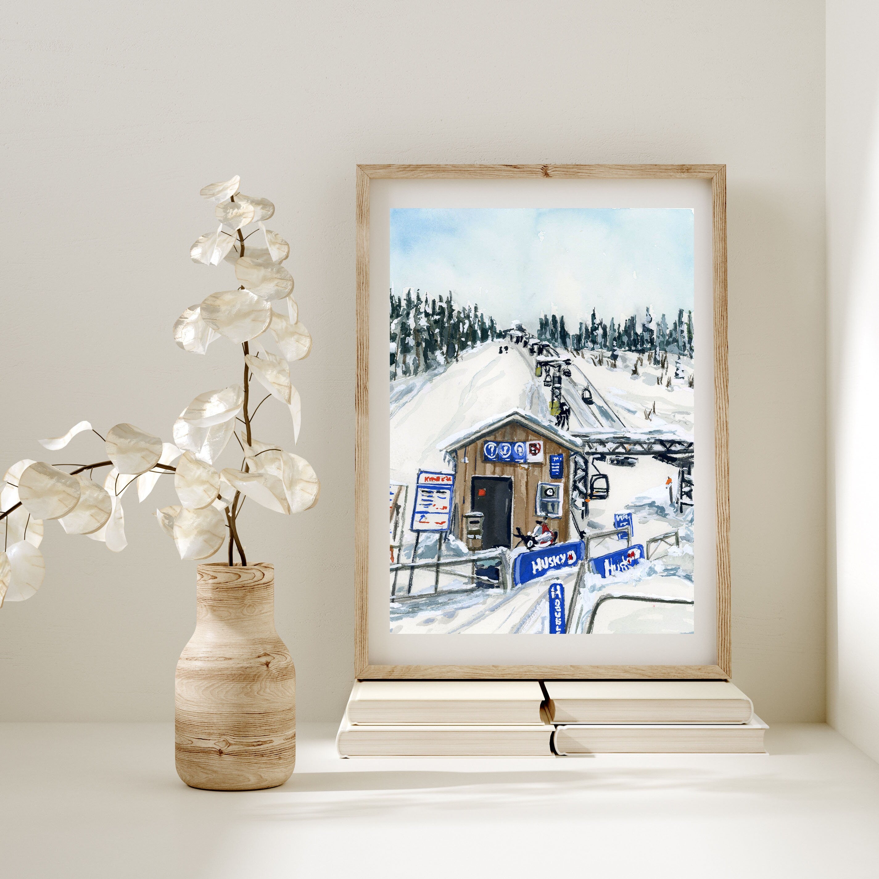 Snowy ski lift print of painting by Medjool Studio. Print of an original gouache painting capturing the serene beauty of a snowy ski hut.