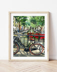 Bike on Amsterdam canal print of painting by Medjool Studio. Print of original gouache painting featuring a close up of a bike on a bridge that has red flowers along the railing looking over the Amsterdam canal.