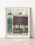 Paris cafe print of painting by Medjool Studio. Print of original gouache painting of the front of a small cafe in Paris, France featuring a burgundy awning, small tables and chairs out front.