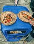 Scar’s Pizza original painting by Medjool Studio. Original gouache painting showing a slice of pizza on top of a vibrant blue garbage bin.