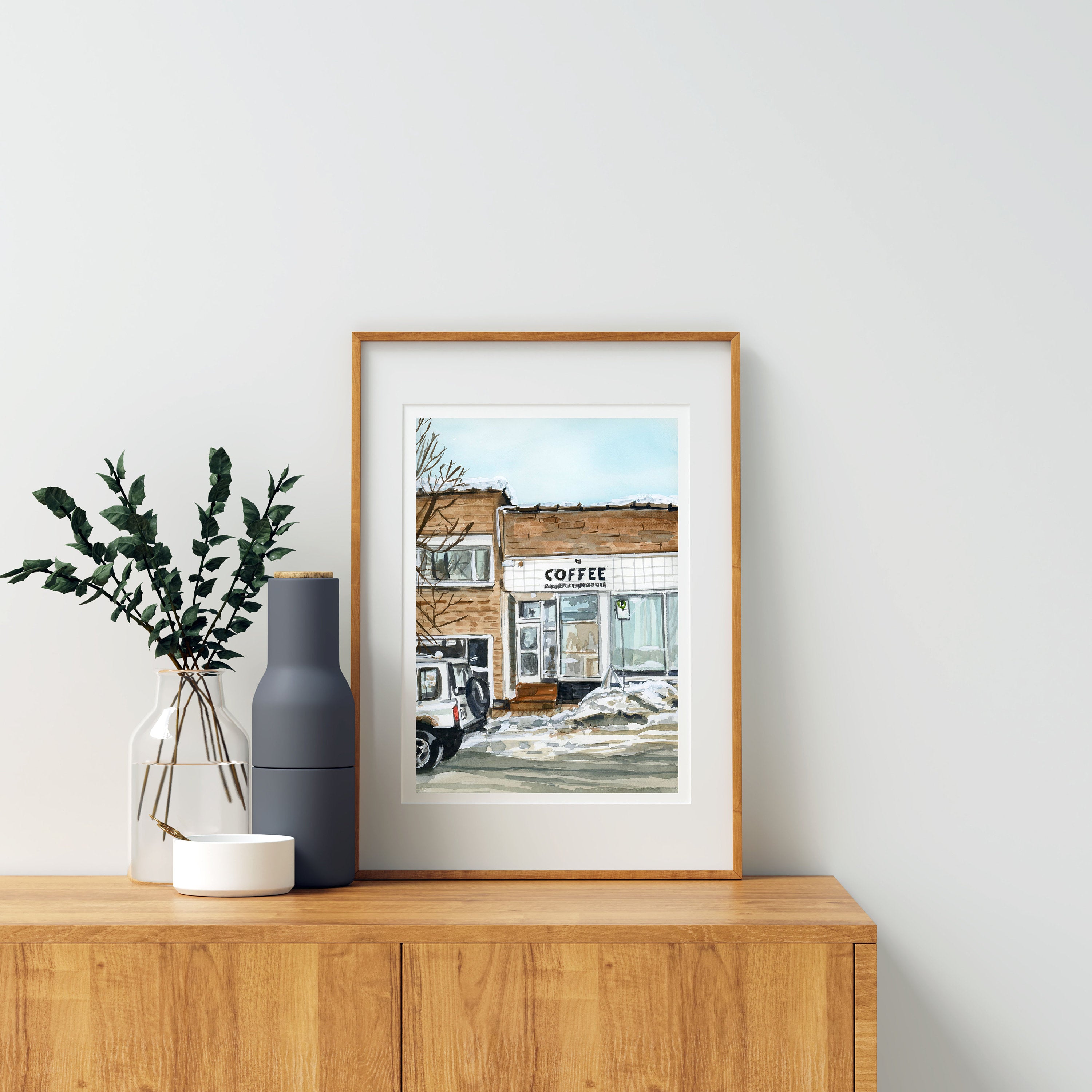 Winter coffee shop print of painting by Medjool Studio. Print of an original gouache painting that captures the charming essence of the mountain town of Kimberly, British Columbia featuring the iconic Kick Turn Coffee Shop.