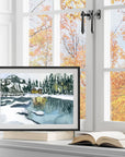 Winter forest and cabin on a lake print of painting by Medjool Studio. Print of an original gouache painting of a cabin lit up an in a winter forest on a lake.