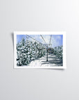 Winter ski lift and forest print of painting by Medjool Studio. Print of an original gouache painting capturing the serene beauty of a ski lift through a row of trees covered in a layer of snow.